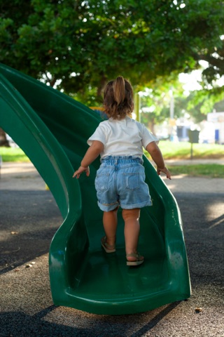 Mia climbing the slide